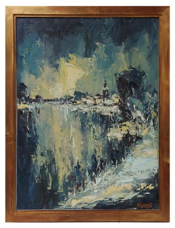 Dorpje met kerktoren aan het water in de winter